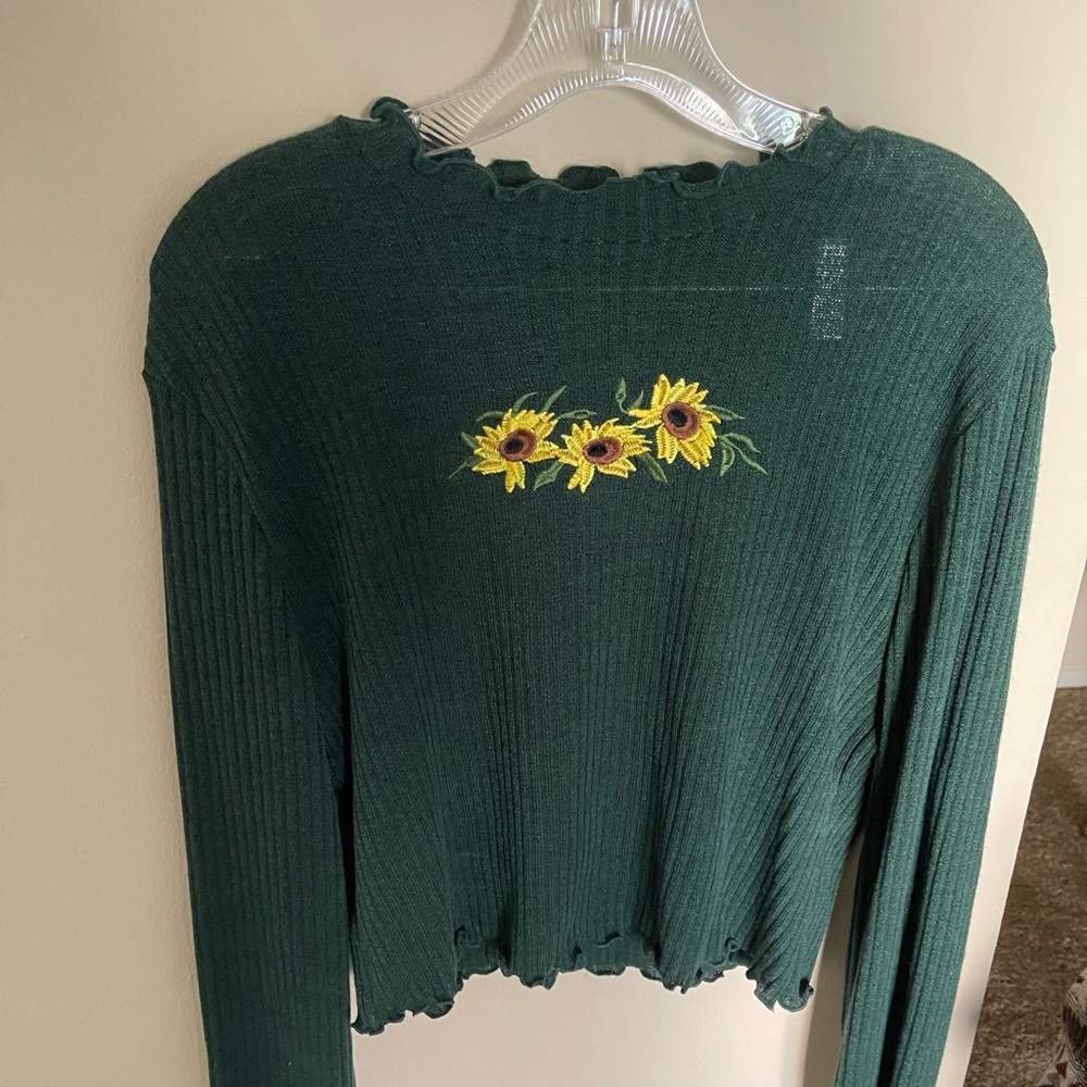 green sweater with sunflowers